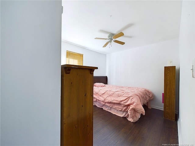 bedroom with dark hardwood / wood-style floors and ceiling fan