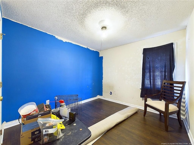 interior space with hardwood / wood-style flooring and a textured ceiling