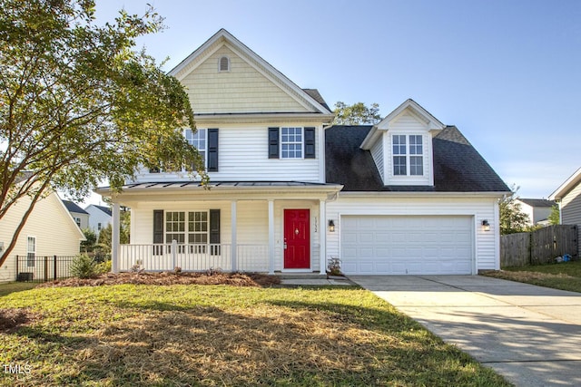 view of front of property featuring a garage, covered porch, and a front lawn