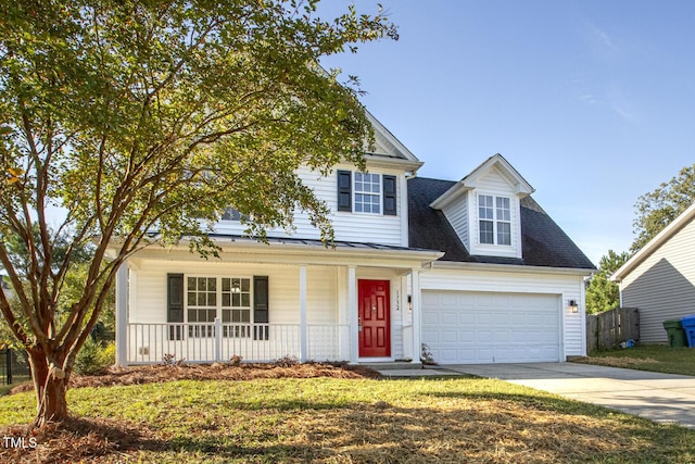 view of front of home featuring a porch, a garage, and a front yard