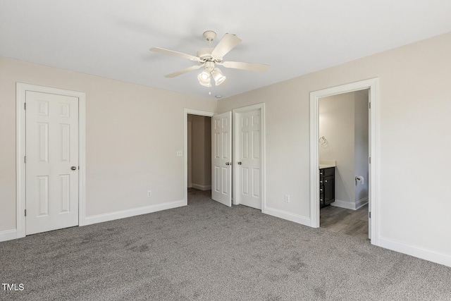 unfurnished bedroom with ensuite bathroom, ceiling fan, and carpet flooring