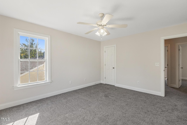 spare room with ceiling fan and carpet