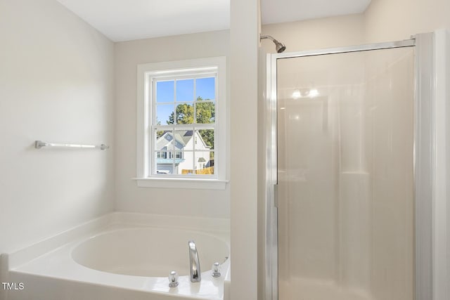 bathroom featuring separate shower and tub