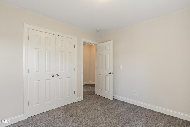 unfurnished bedroom featuring carpet floors and a closet