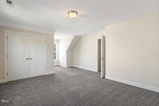 bonus room with dark carpet