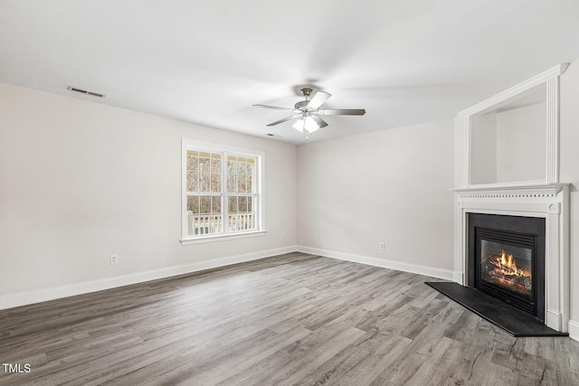 unfurnished living room featuring hardwood / wood-style floors and ceiling fan