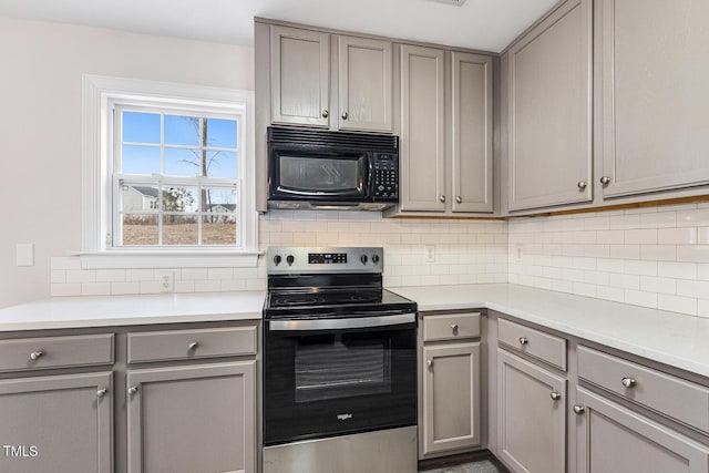 kitchen featuring stainless steel range with electric stovetop, tasteful backsplash, and gray cabinetry