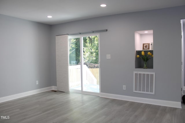 unfurnished room with wood-type flooring