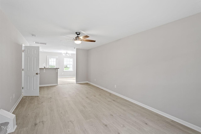 unfurnished room with ceiling fan and light wood-type flooring