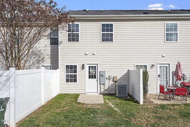 back of property with a patio, a yard, and cooling unit