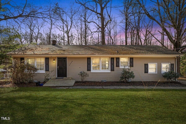 ranch-style house with a lawn