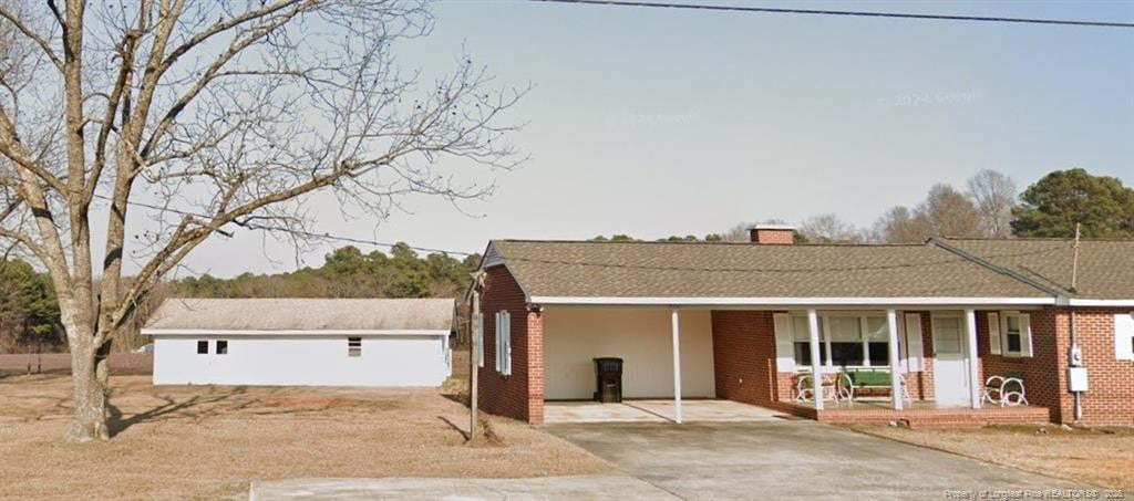 view of front of house featuring a carport and covered porch