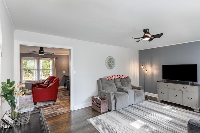 living room featuring wood-type flooring, ornamental molding, and ceiling fan