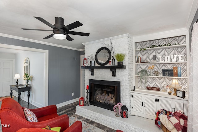 living room featuring crown molding, ceiling fan, a fireplace, and hardwood / wood-style floors