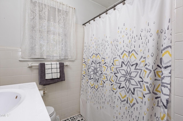 bathroom featuring tile walls, vanity, a shower with curtain, and toilet