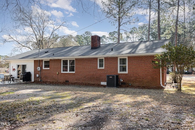 rear view of property featuring central AC