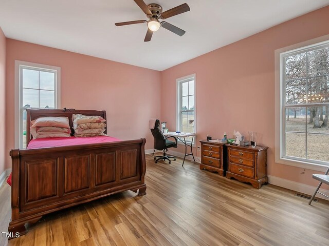 bedroom with ceiling fan and light hardwood / wood-style flooring