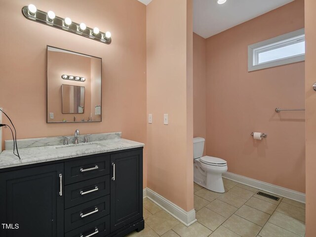 bathroom with vanity, tile patterned floors, and toilet