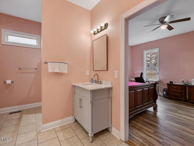 bathroom featuring vanity, wood-type flooring, and ceiling fan