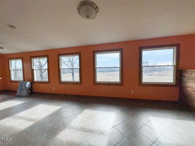 spare room featuring light tile patterned floors