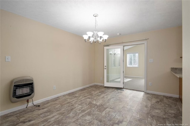 unfurnished dining area with a chandelier and heating unit