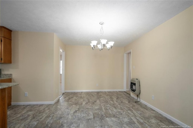 unfurnished dining area featuring an inviting chandelier and heating unit