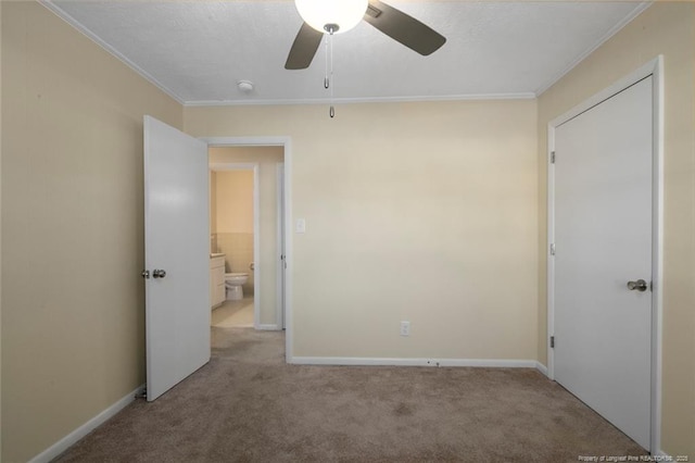 unfurnished bedroom featuring crown molding, light colored carpet, and ceiling fan