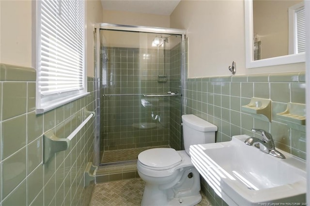 bathroom featuring tile patterned flooring, toilet, sink, and walk in shower