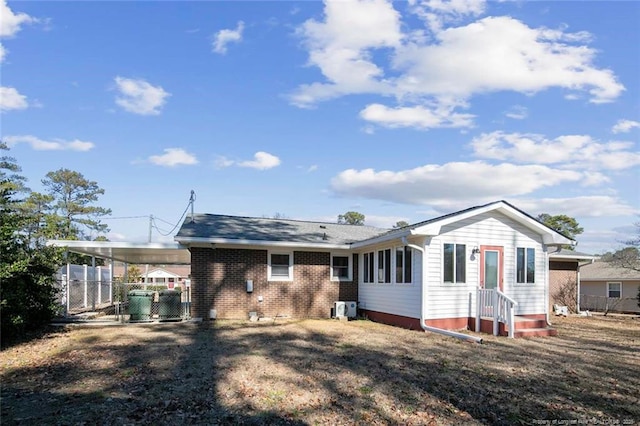 back of property with a carport