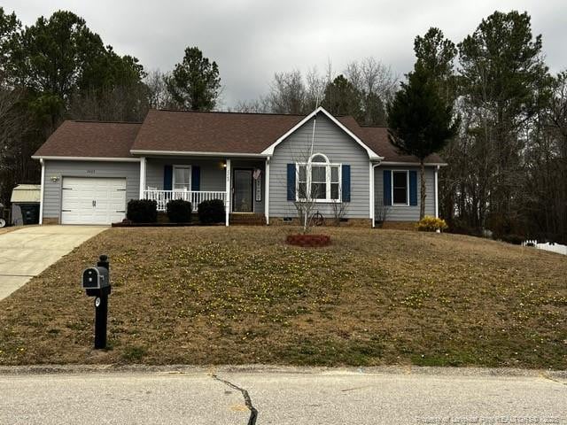 single story home featuring a garage, covered porch, and a front lawn