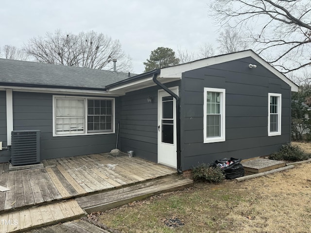 back of house featuring a wooden deck and cooling unit