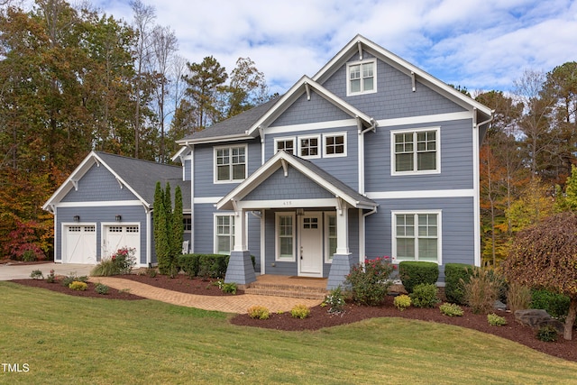 craftsman-style home featuring a garage and a front yard