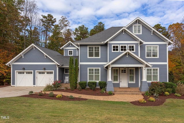 craftsman inspired home featuring a garage and a front yard