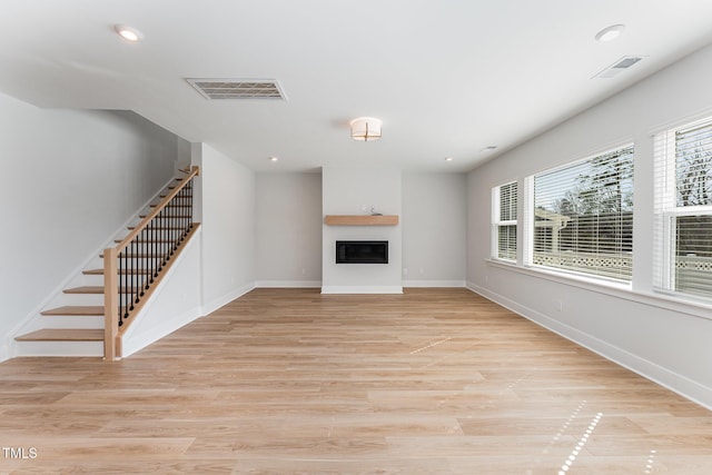 unfurnished living room with light hardwood / wood-style floors