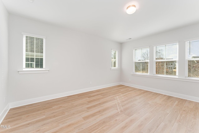 spare room featuring light wood-type flooring