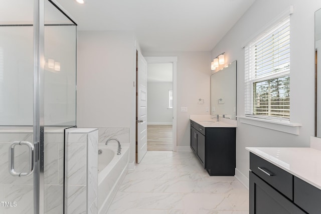 bathroom featuring vanity and shower with separate bathtub