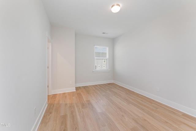 spare room featuring light wood-type flooring