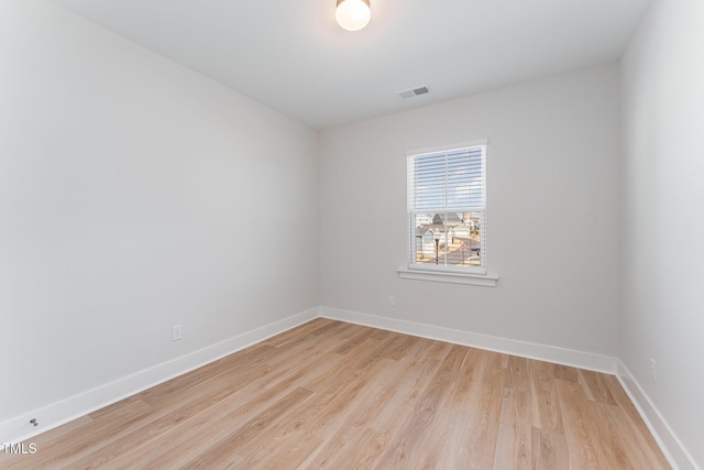 spare room featuring light hardwood / wood-style flooring