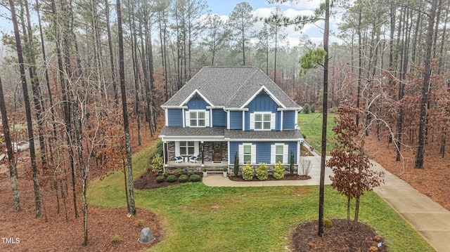 view of front facade with a front yard and covered porch