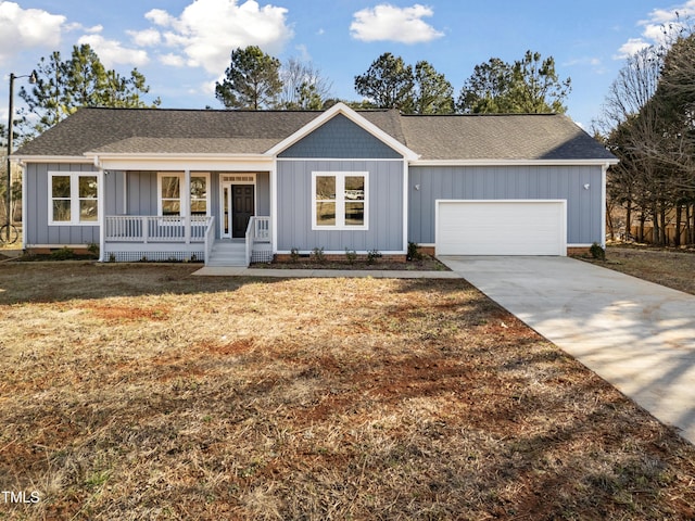 single story home with a garage, covered porch, and a front lawn