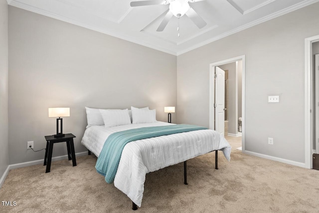 carpeted bedroom with ensuite bath, a ceiling fan, baseboards, and ornamental molding