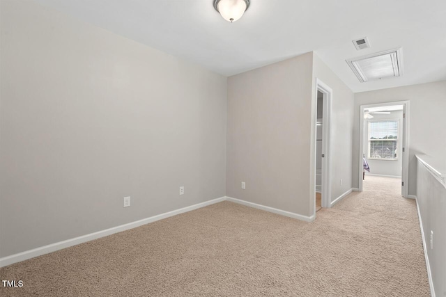 interior space with light colored carpet, visible vents, and baseboards