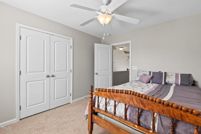 carpeted bedroom with a closet, a ceiling fan, and baseboards