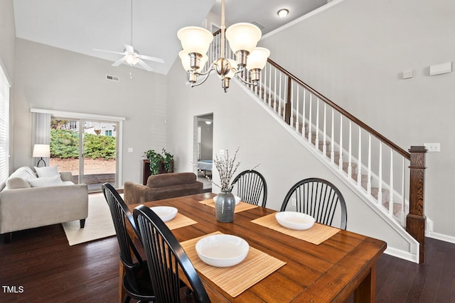 dining space with stairway, visible vents, high vaulted ceiling, wood-type flooring, and ceiling fan with notable chandelier