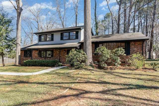 view of front of house featuring brick siding, crawl space, a front yard, and fence