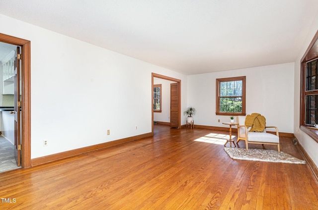 sitting room featuring light wood finished floors and baseboards