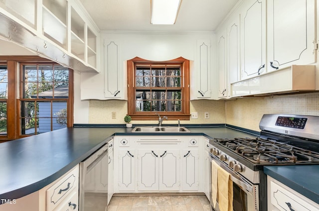 kitchen with dark countertops, stainless steel appliances, and a sink