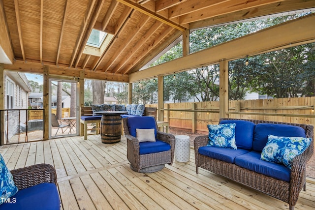 sunroom / solarium with a wealth of natural light and vaulted ceiling with skylight