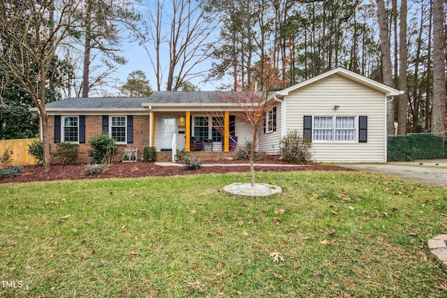 ranch-style house with a porch and a front yard