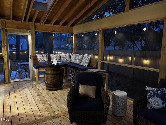 wooden terrace featuring an outdoor living space with a fire pit